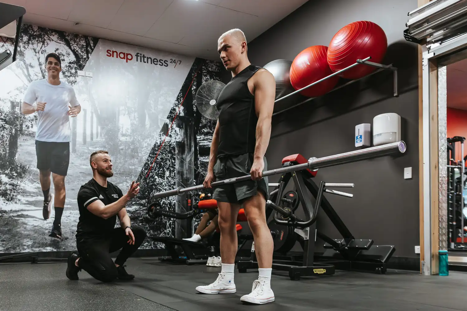 Jamie training a client through a deadlift